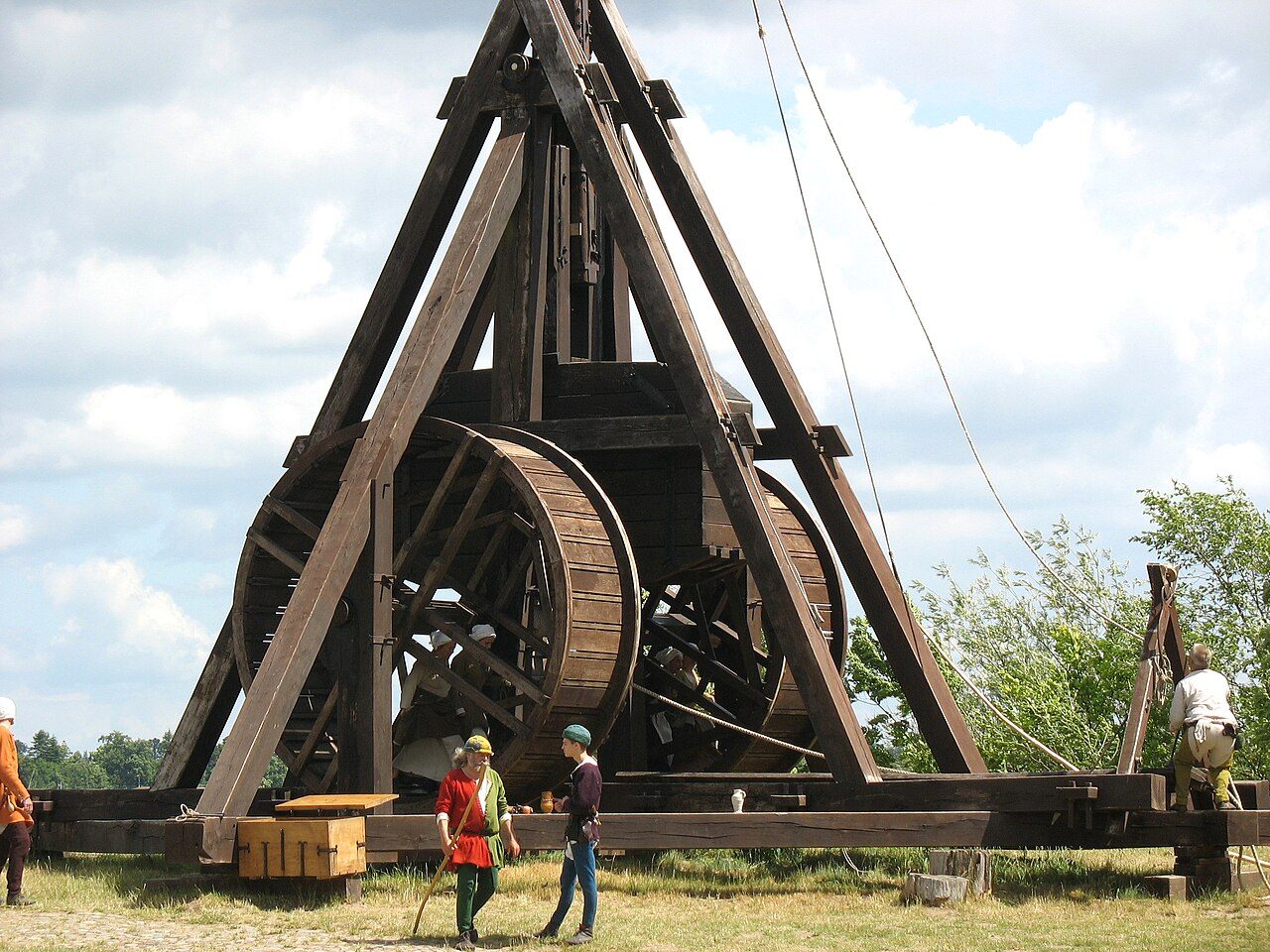 A full-size reconstructed trebuchet with two treadwheels, its long beam raised against the sky, at the Medieval Centre in Nykøbing Falster